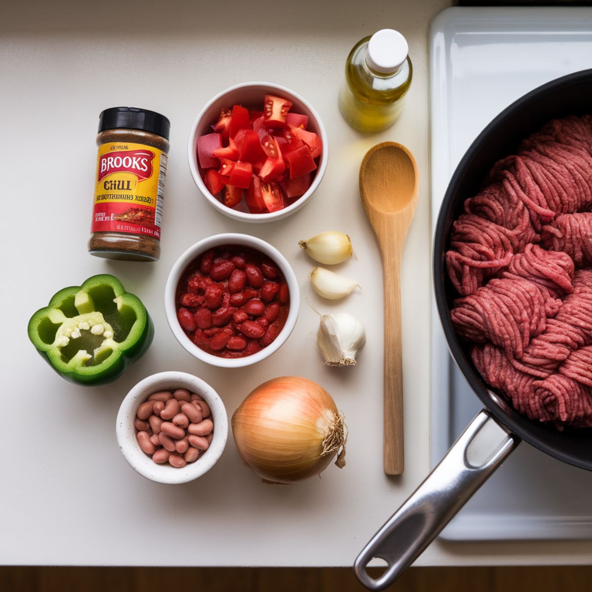 Ingredients for Brooks seasoning chili, including ground beef, chili seasoning, diced tomatoes, kidney beans, green pepper, garlic, and onion