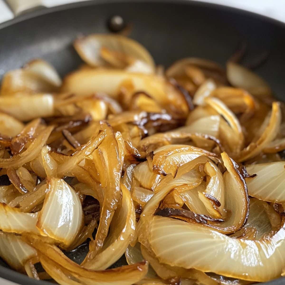 Golden brown caramelized onions in pan. Key to the deep flavor of French onion pot roast.