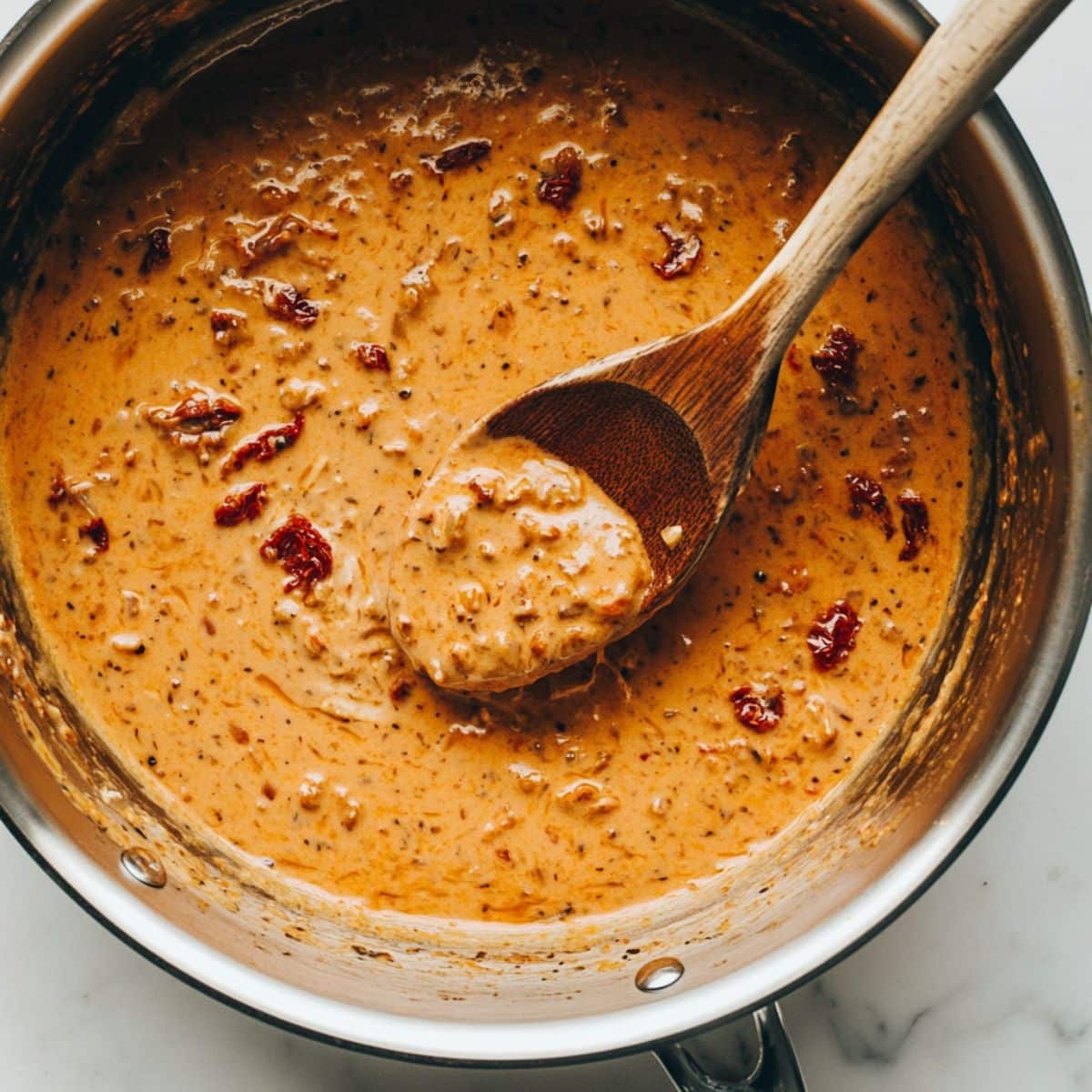 Creamy parmesan tomato sauce with sun-dried tomatoes melting together. Sauce base for Marry Me Chicken Pasta.