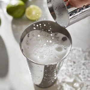 Cocktail shaker in motion during dry shake.