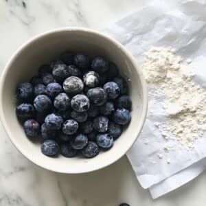 Fresh blueberries coated in flour to prevent sinking and bleeding. First step to fluffy, picture-perfect waffles.