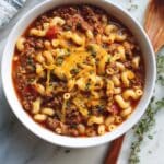 Hearty American goulash with elbow pasta and ground beef in tomato sauce.