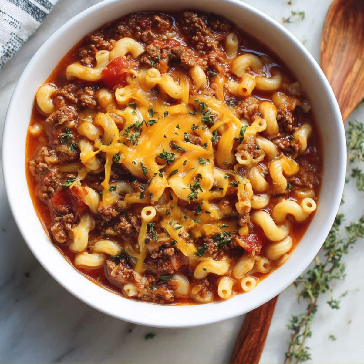Hearty American goulash with elbow pasta and ground beef in tomato sauce.