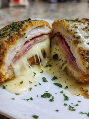 Sliced chicken cordon bleu with melted cheese and ham topped in creamy Dijon sauce.