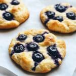 Blueberry fluffy cottage cheese cloud bread freshly baked with golden edges and juicy blueberries on top.