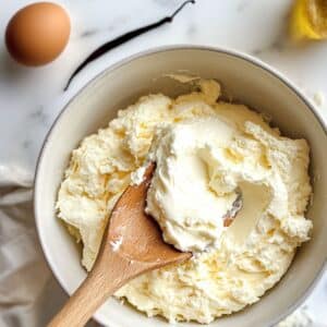 Gently folding stiff egg whites into cottage cheese batter for airy cloud bread texture.