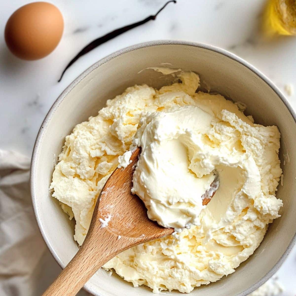 Gently folding stiff egg whites into cottage cheese batter for airy cloud bread texture.