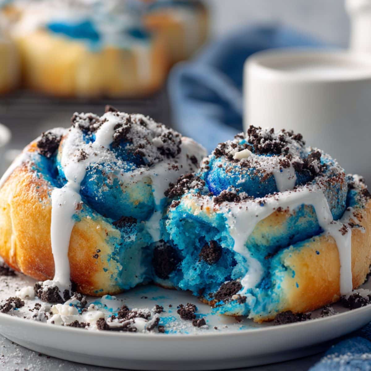 Homemade Cookie Monster cinnamon rolls with bright blue dough, white glaze, and cookie crumbles. Fun Sesame Street themed breakfast treats with vibrant blue swirls and cream cheese frosting.