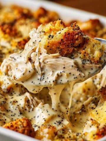 creamy poppy seed chicken casserole with golden crushed Ritz cracker topping in a white baking dish; comforting, cheesy, and ready to serve for an easy weeknight family dinner.