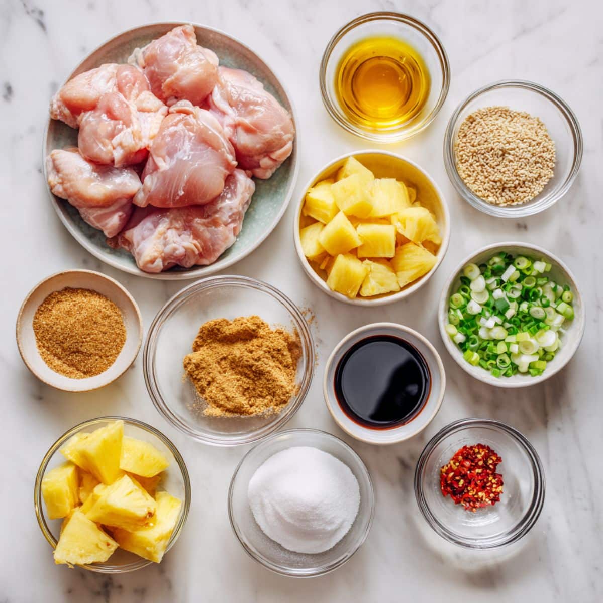 Overhead photo of ingredients for Brown Sugar Pineapple Chicken including chicken, pineapple, brown sugar, soy sauce, and seasonings.