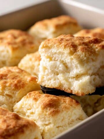 Golden, fluffy butter swim biscuits baked in a pan, with a tender, layered texture.