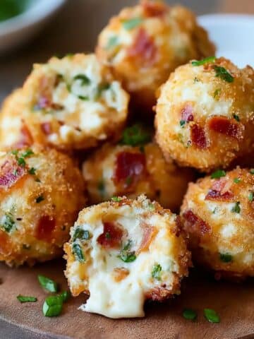 Crispy bacon jalapeño popper cheese balls with creamy melted cheese and fresh herbs inside.