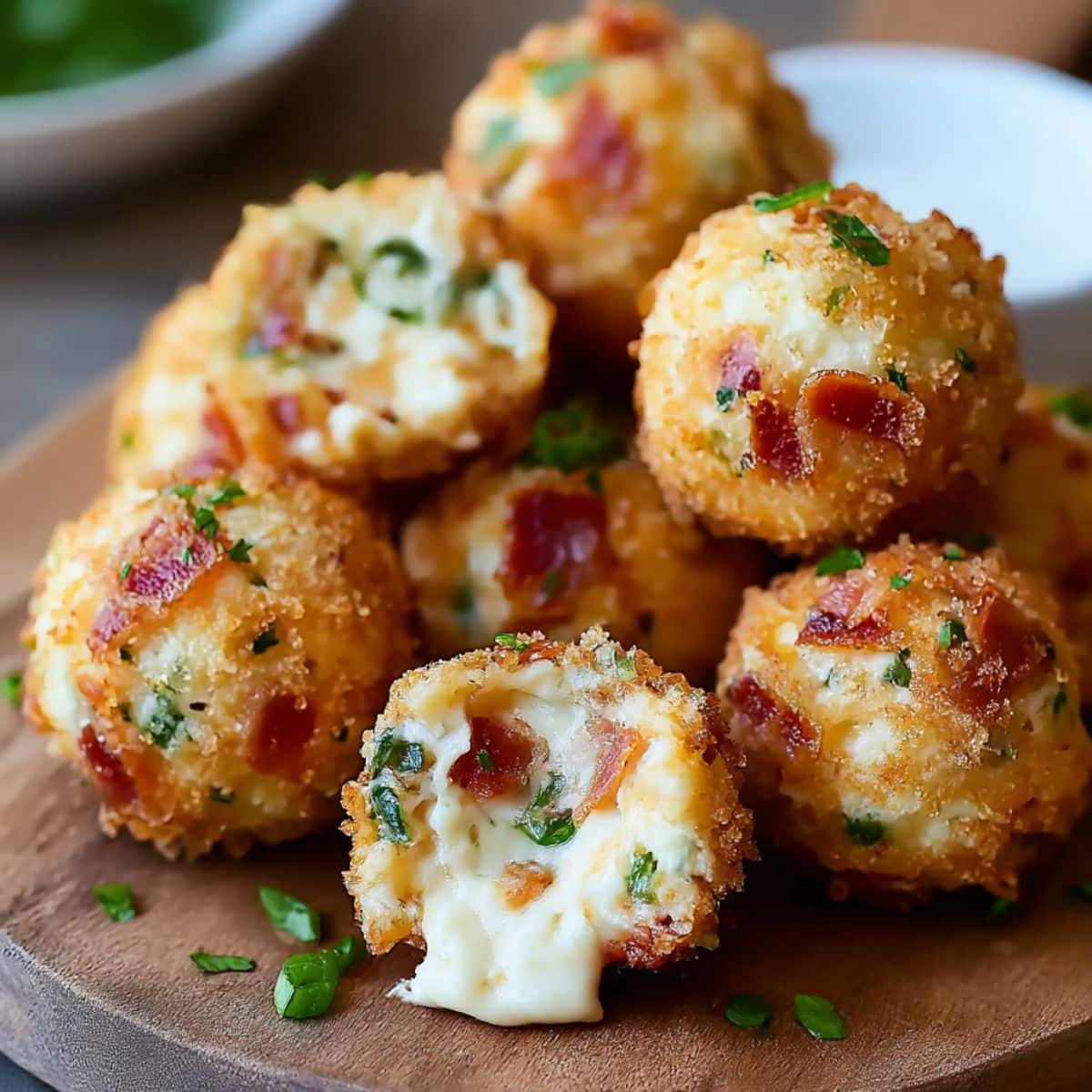 Crispy bacon jalapeño popper cheese balls with creamy melted cheese and fresh herbs inside.