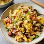 Homemade breakfast fried rice with crispy bacon, scrambled eggs, and green onions.