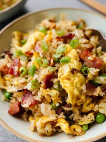 Homemade breakfast fried rice with crispy bacon, scrambled eggs, and green onions.