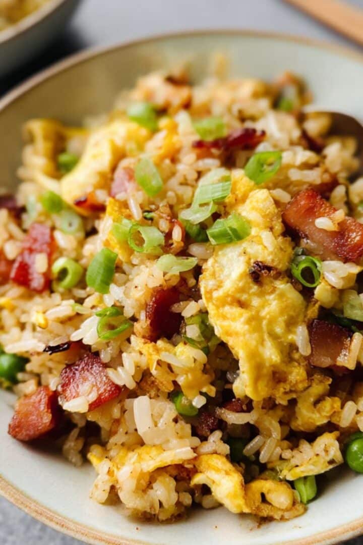 Homemade breakfast fried rice with crispy bacon, scrambled eggs, and green onions.