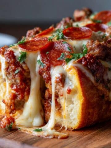 Cheesy stuffed garbage bread with pepperoni, sausage, and melted mozzarella.
