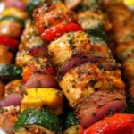 Grilled chicken kabobs with colorful vegetables, charred edges, and fresh herbs for the perfect summer meal.
