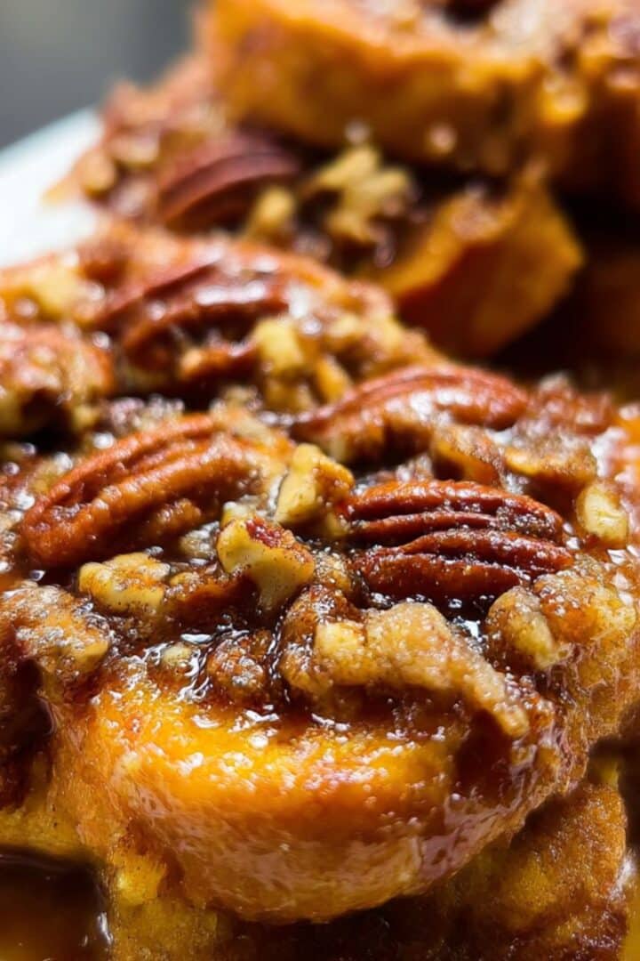 Golden overnight pecan pie french toast topped with caramelized pecans and sticky brown sugar syrup.