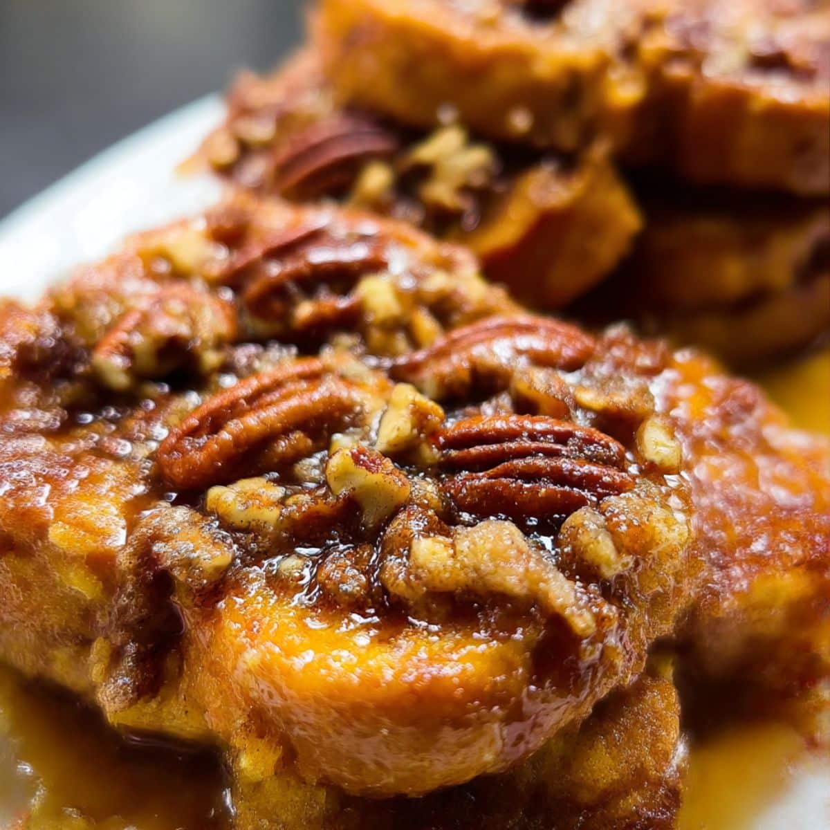 Golden overnight pecan pie french toast topped with caramelized pecans and sticky brown sugar syrup.