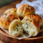 Golden Pillsbury biscuit garlic butter cheese bombs with melted mozzarella center.