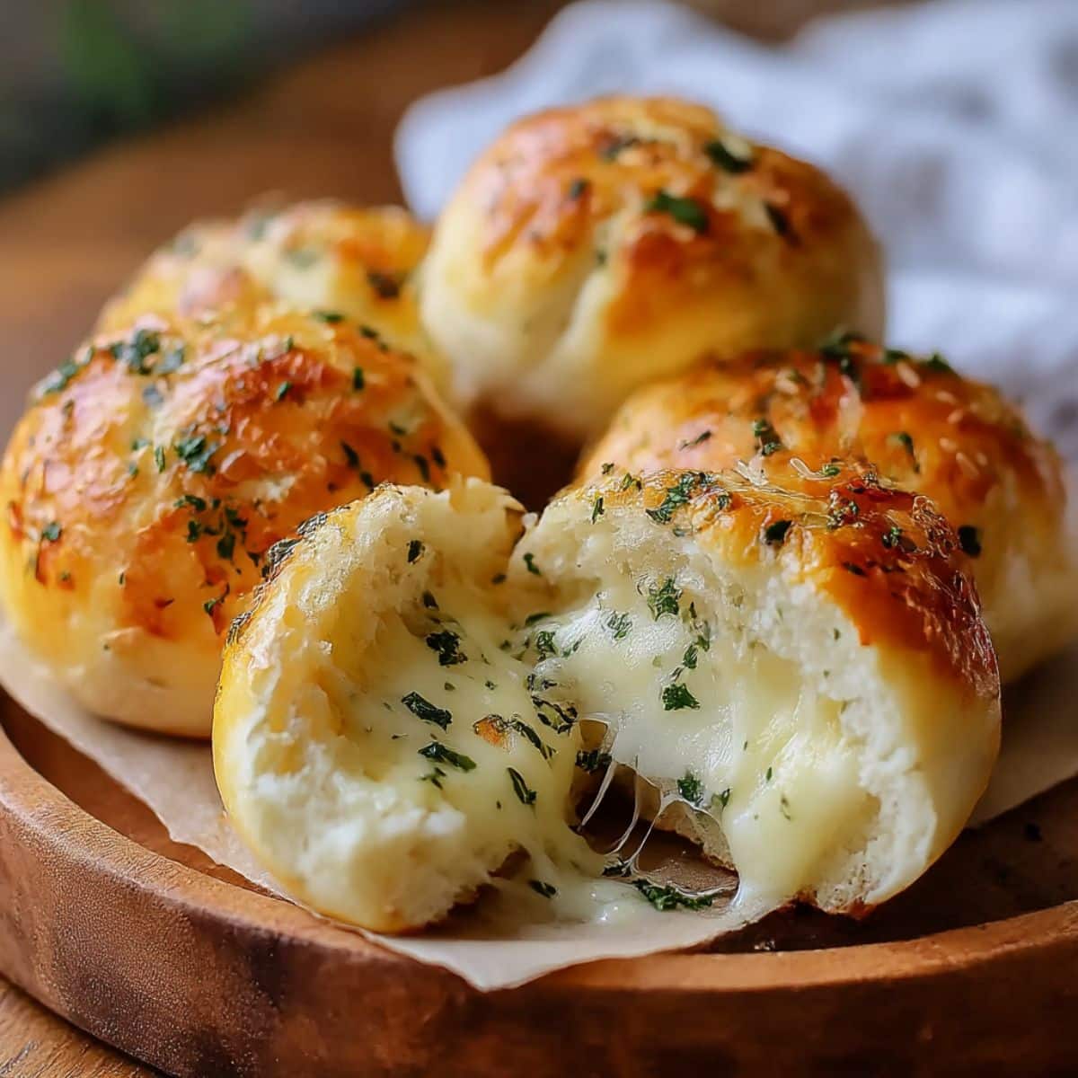 Golden Pillsbury biscuit garlic butter cheese bombs with melted mozzarella center.