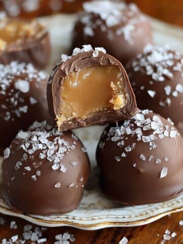 Homemade salted caramel truffles coated in dark chocolate and topped with sea salt.