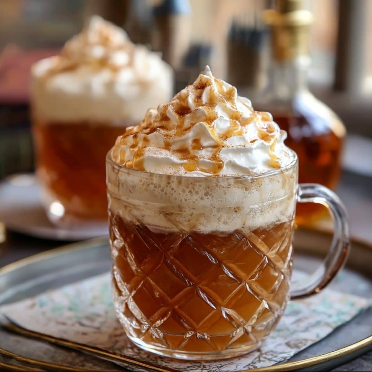 Homemade Harry Potter butterbeer topped with whipped cream and caramel drizzle.