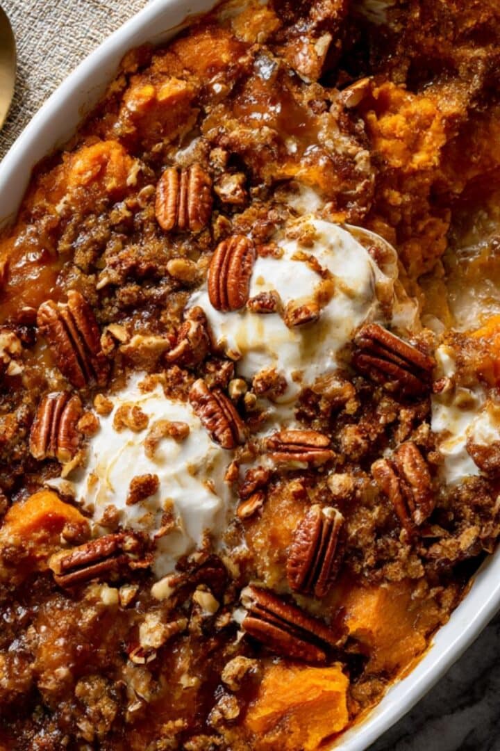 Maple sweet potato casserole topped with toasted pecans and melted marshmallow swirls.