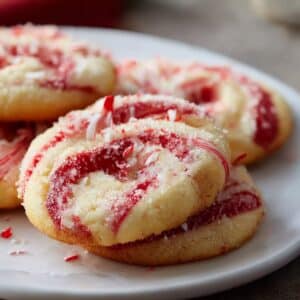 Festive peppermint swirl cookies with red and white candy cane spirals topped with crushed peppermint.