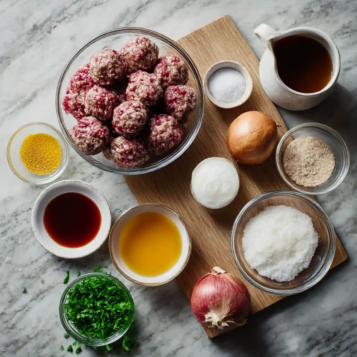 Ingredients for Salisbury steak meatballs with ground beef, onions, breadcrumbs, and gravy components.