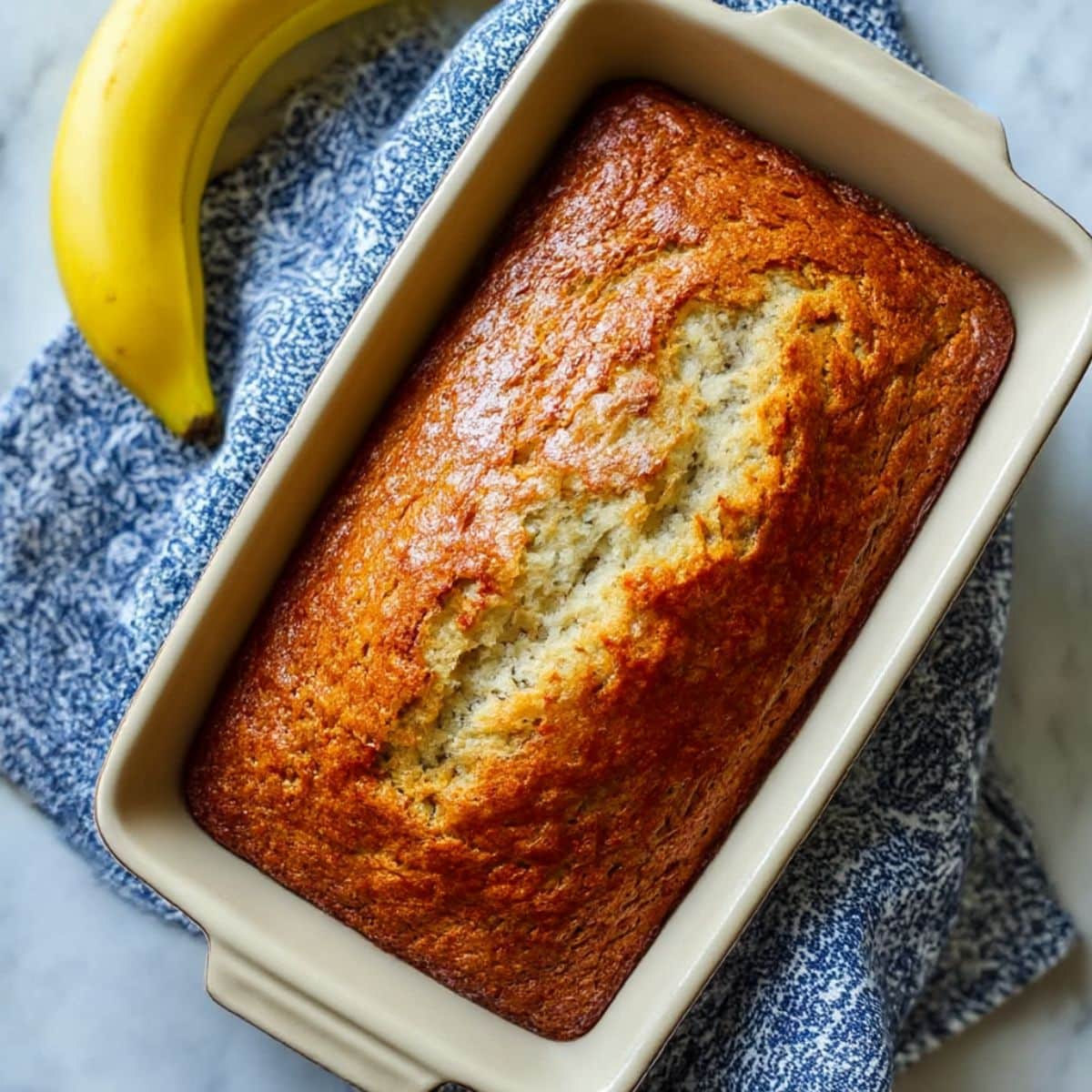 Homemade banana bread recipe 2 bananas, baked golden in a loaf pan