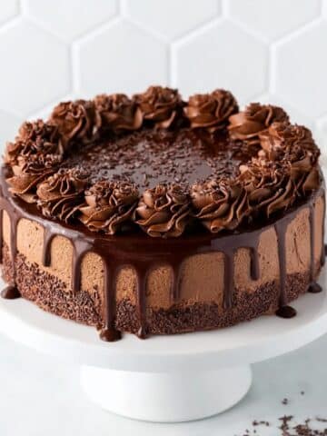 Hot fudge brownie cheesecake topped with chocolate ganache and whipped chocolate frosting