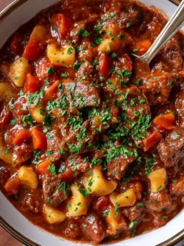 Authentic Hungarian goulash with tender beef, potatoes, and peppers simmered in rich paprika broth.