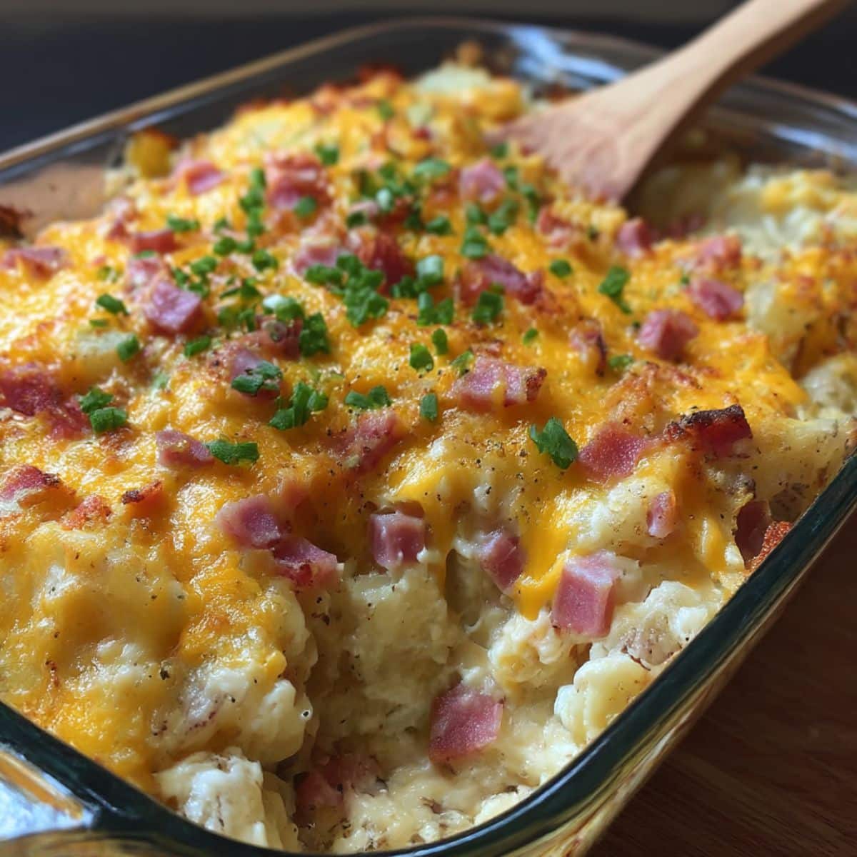 Cheesy ham potato casserole baked until golden with diced ham, melted cheddar, and fresh chives.